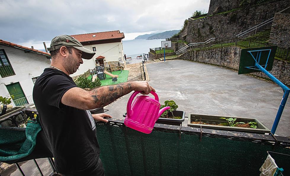 Iker Abiña riega sus plantas.