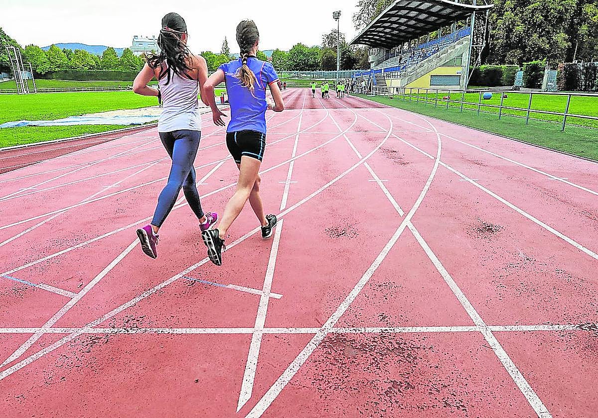 Dos atletas se ejercitan sobre el tartán de Mendizorroza antes de que se acometiera su reforma.