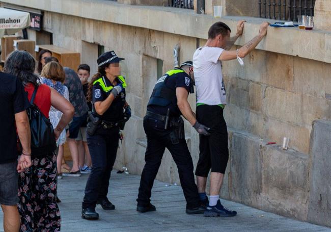 Agentes locales cachean a un joven en el Casco Viejo.