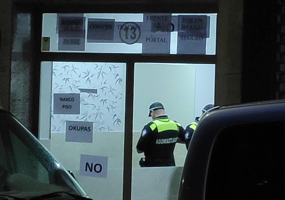 Agentes de la Policía y la Ertzaintza permanecen en el portal tras la salida de los okupas del 'narcopiso'.