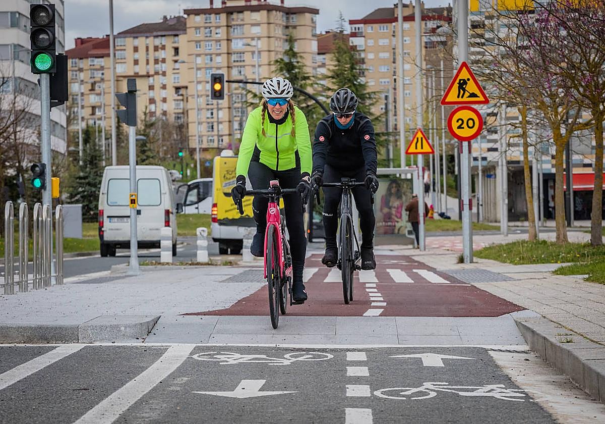 Dos ciclistas pedalean por un bidegorri de Vitoria.