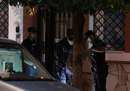 Agentes de policía en el portal de la vivienda donde ha sido hallado el cadáver.