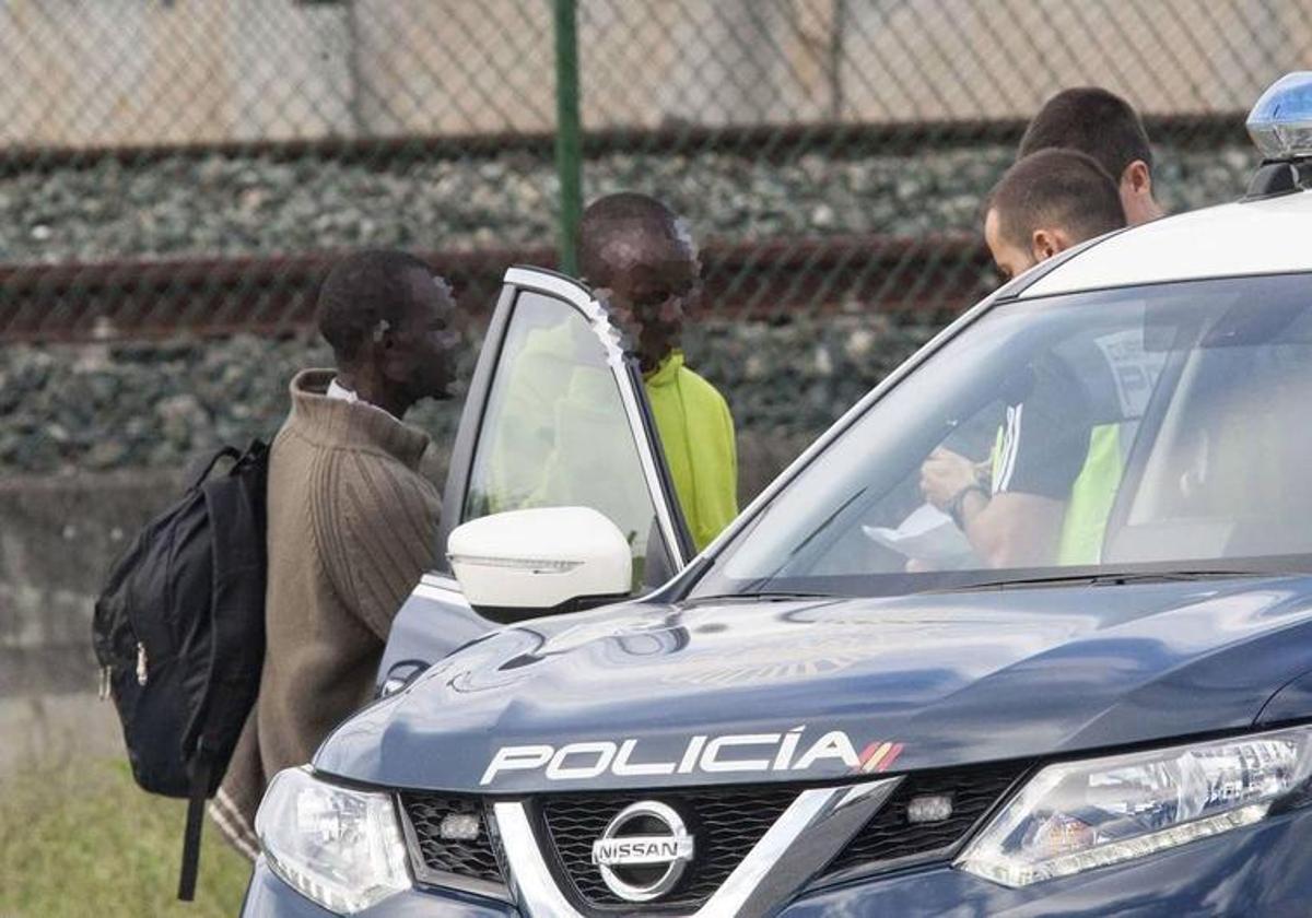 Agentes de la Policía Nacional identifican a dos migrantes en la frontera de Irún.