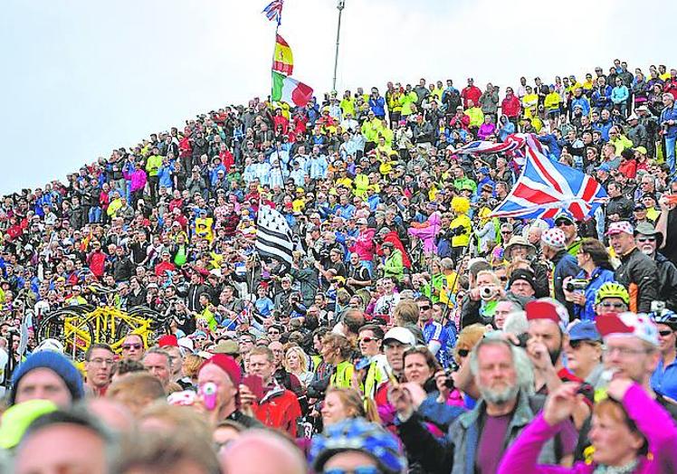 Imagen principal - Yorkshire 2014. Multitud. Los aficionados se agolparon en la salida de Leeds. | San sebastián 1992. De amarillo. Induráin ganó el prólogo donostiarra. | Bruselas 2019. Presentación. El equipo Katusha cruza las Galerías Reales. 