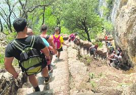 Un grupo de turistas bajan las empinadas escaleras que llevan al faro.