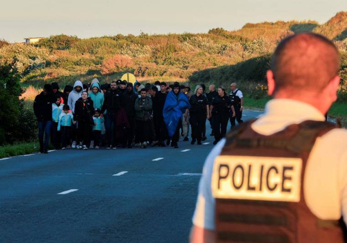 La Policía gala vigila a un grupo de emigrantes en Calais.