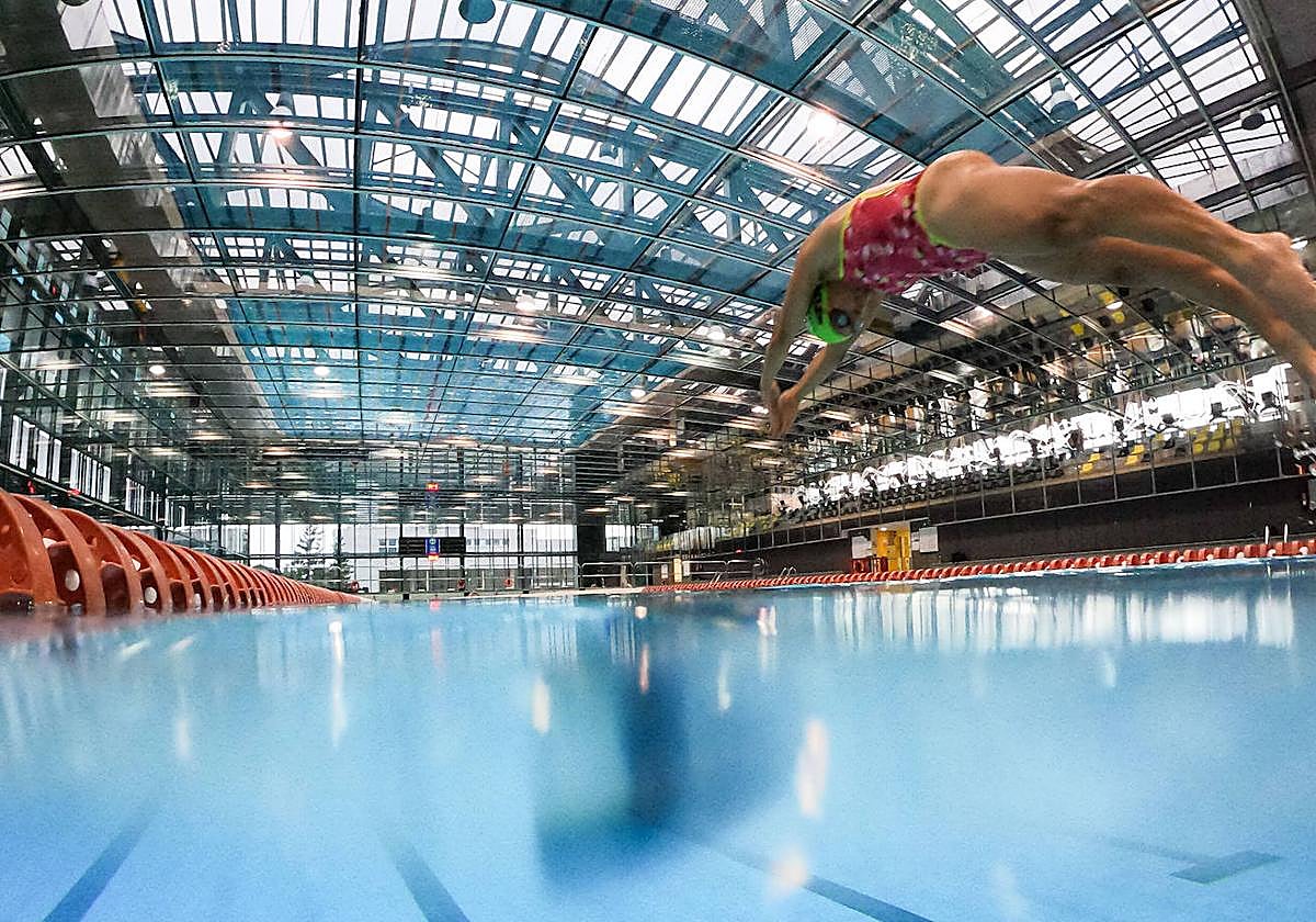 Una mujer se zambulle en la piscina olímpica de Mendizorroza.