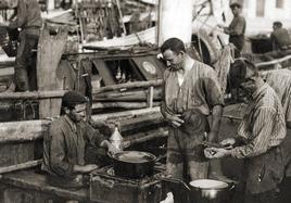 Pescadores vascos preparando la marmita en el puerto de Gijón, foto de Constantino Fernández (1926). Museu del Pueblu d'Asturies.