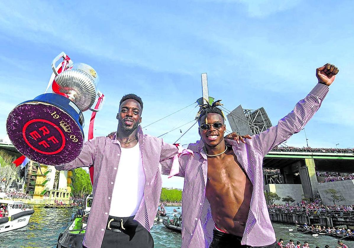 Los Williams posan con la Copa al paso de la gabarra por el museo Guggenheim.