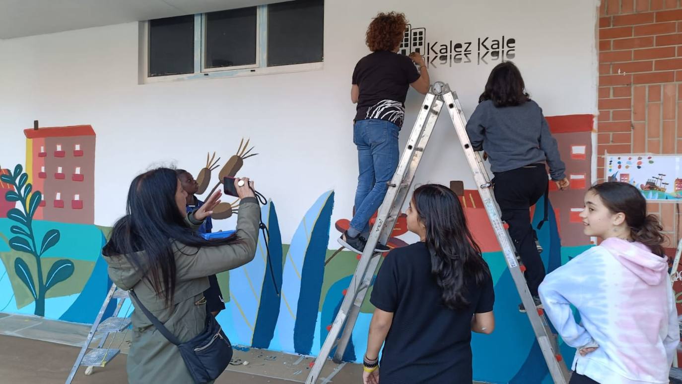 En imágenes: 150 vecinos de Ibaiondo pintan un mural de 24 metros