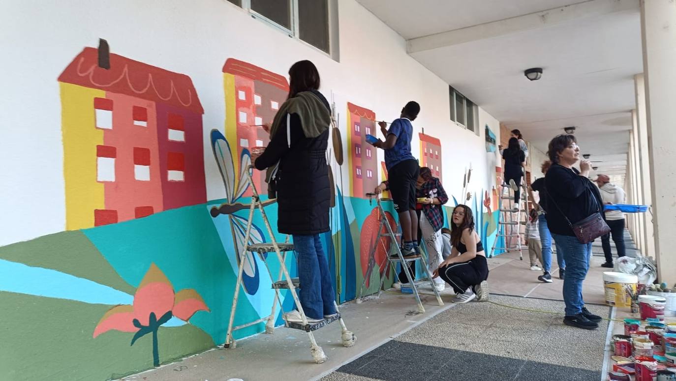 En imágenes: 150 vecinos de Ibaiondo pintan un mural de 24 metros