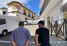 Dos vecinos de Zafarraya ante el cordón policial y la casa donde ha sucedido todo.