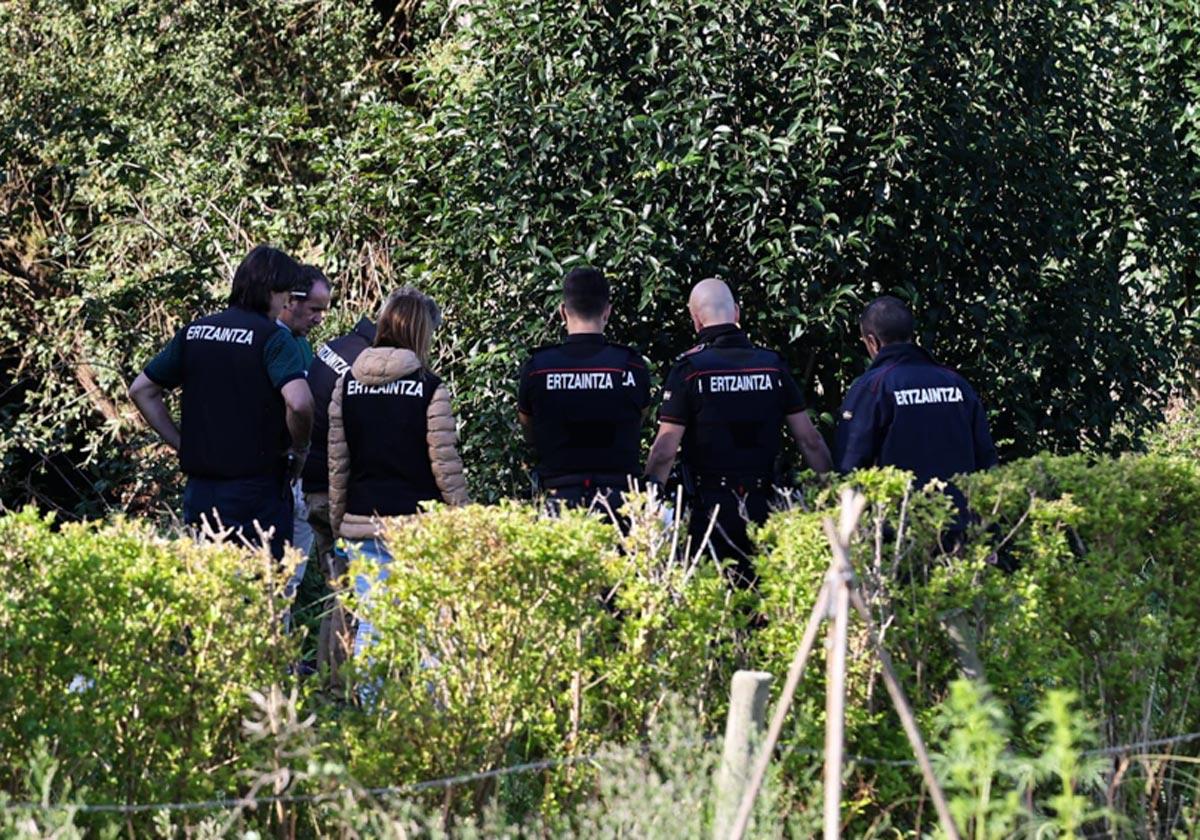 Agentes de la Ertzaintza inspeccionan la zona donde se ha localizado el cuerpo.