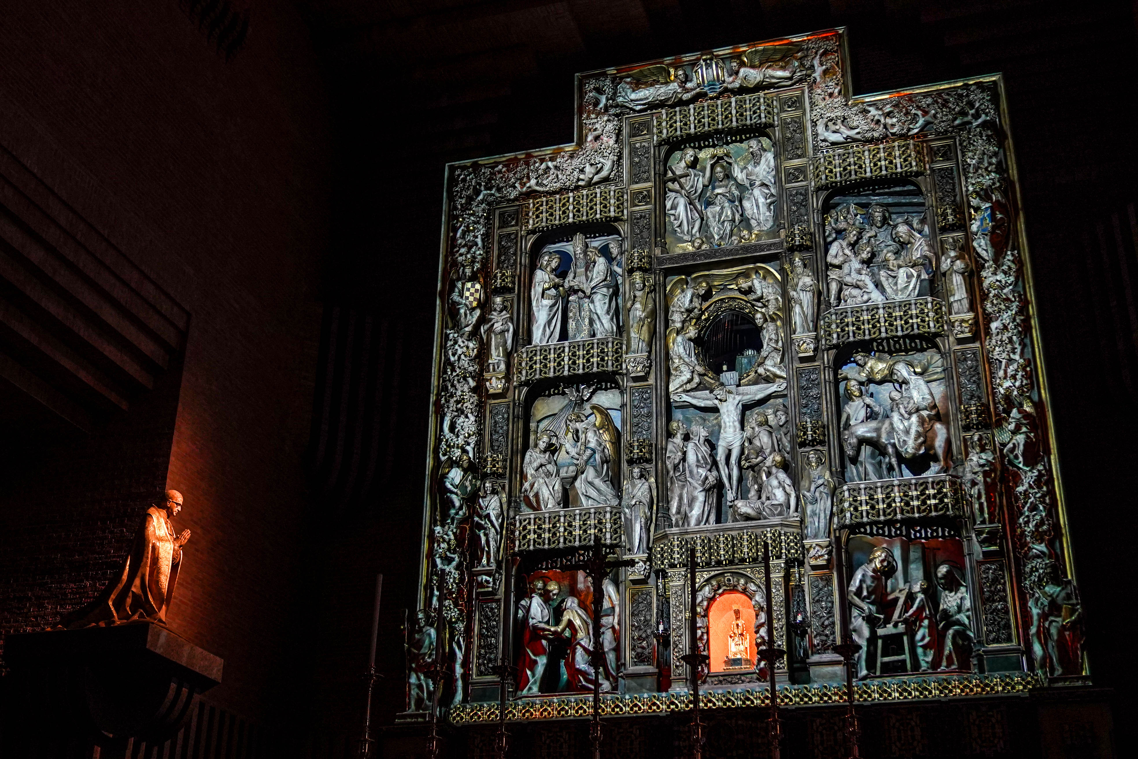 El retablo principal, con la talla de la virgen y figuras de alabastro, y la escultura de San Josemaría.