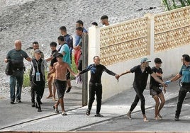 Jóvenes magrebíes tras llegar a nado a la playa de Ceuta.