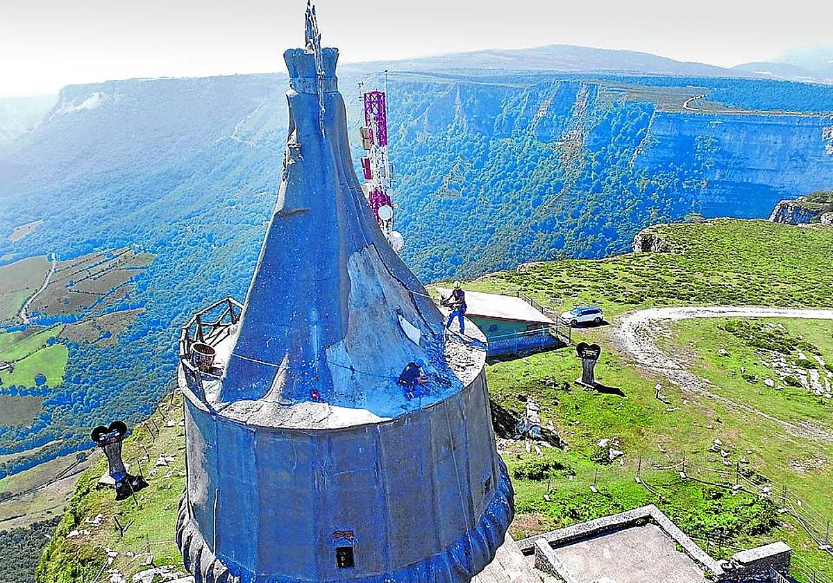 Unos obreros trabajan en la imponente figura de la Virgen que preside la cima.