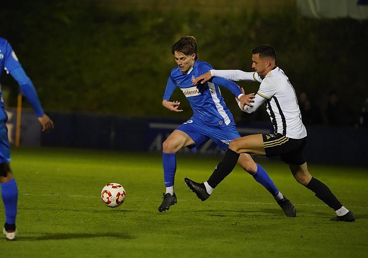 Yuste trata de sacar el balón jugado ante la presión del exazul Koldo Obieta.