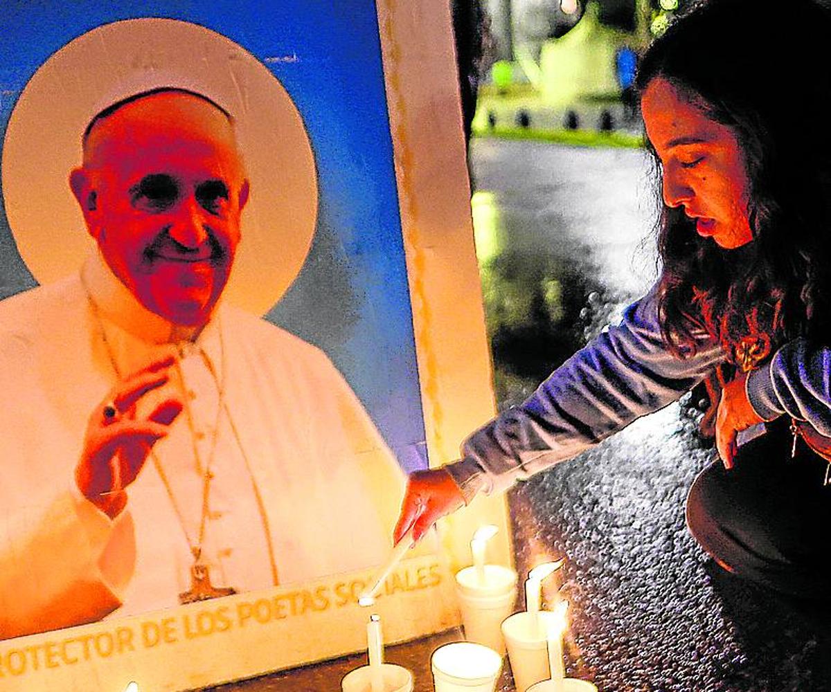 Una mujer reza por el Papa Francisco tras su fallecimiento.