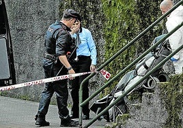 Empleados de una funeraria trasladan a uno de los cadáveres tras el crimen y posterior suicidio del asesino en el barrio de Larraskitu, en Rekalde.