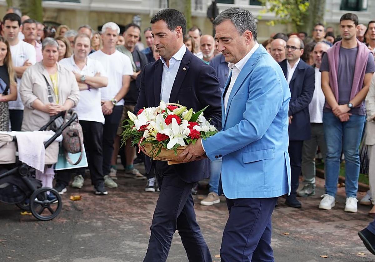 Imanol Pradales y Aitor Esteban realizan la ofrenda floral ante la estatua de Sabino Arana durante el acto por el 130 aniversario del PNV en los Jardines de Albia de Bilbao.