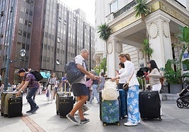 Turistas a la salida del hotel Carlton en Bilbao.
