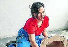 June Crespo trabaja en el estudio con una de sus obras