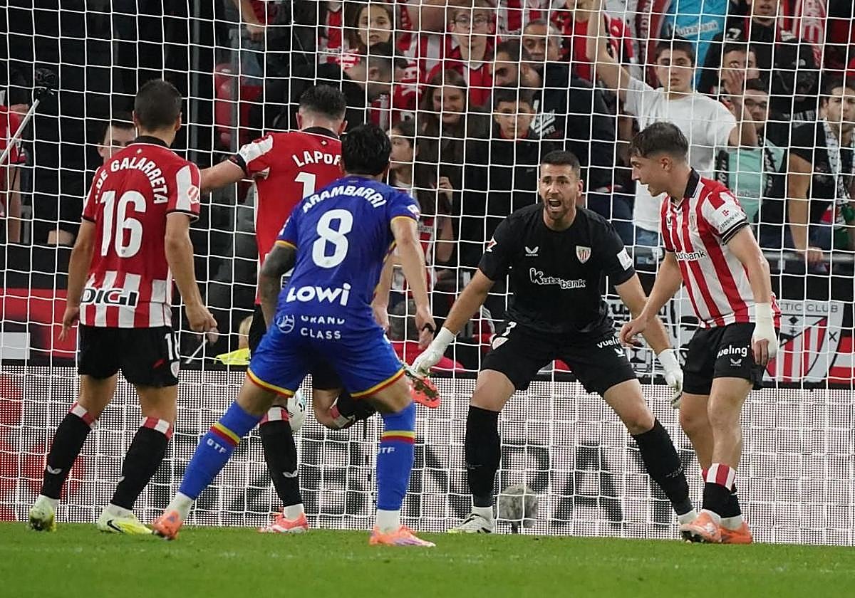 Unai Simón atento ante un despeje de balón de Laporte.