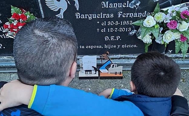 Mikel goes to his father's grave with his son.