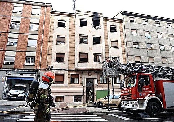 Los bomberos sofocando el fuego del edificio de la avenida de Torrelavega, 27.