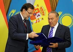 El presidente kazajo, Nursultan Nazarbayeb, entrega el regalo a Mariano Rajoy. / Ilyas Omarov (Afp)