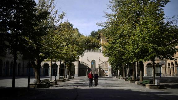 Dos hombres pasean por una calle de Guernica. 