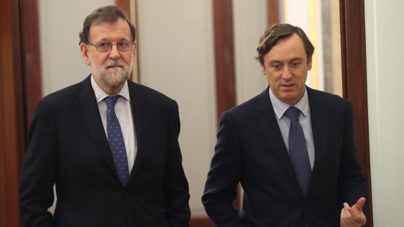 El presidente del Gobierno, Mariano Rajoy (i), junto al portavoz parlamentario del PP, Rafael Hernando (d).