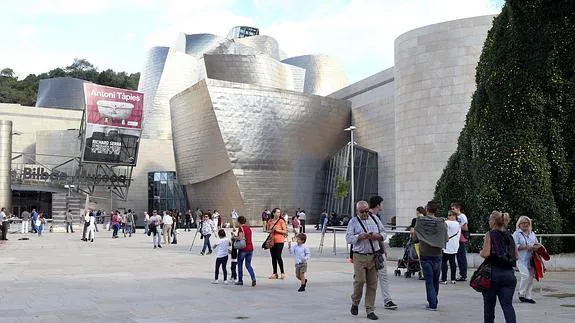 Varios turistas pasean por el exterior del Guggenheim.