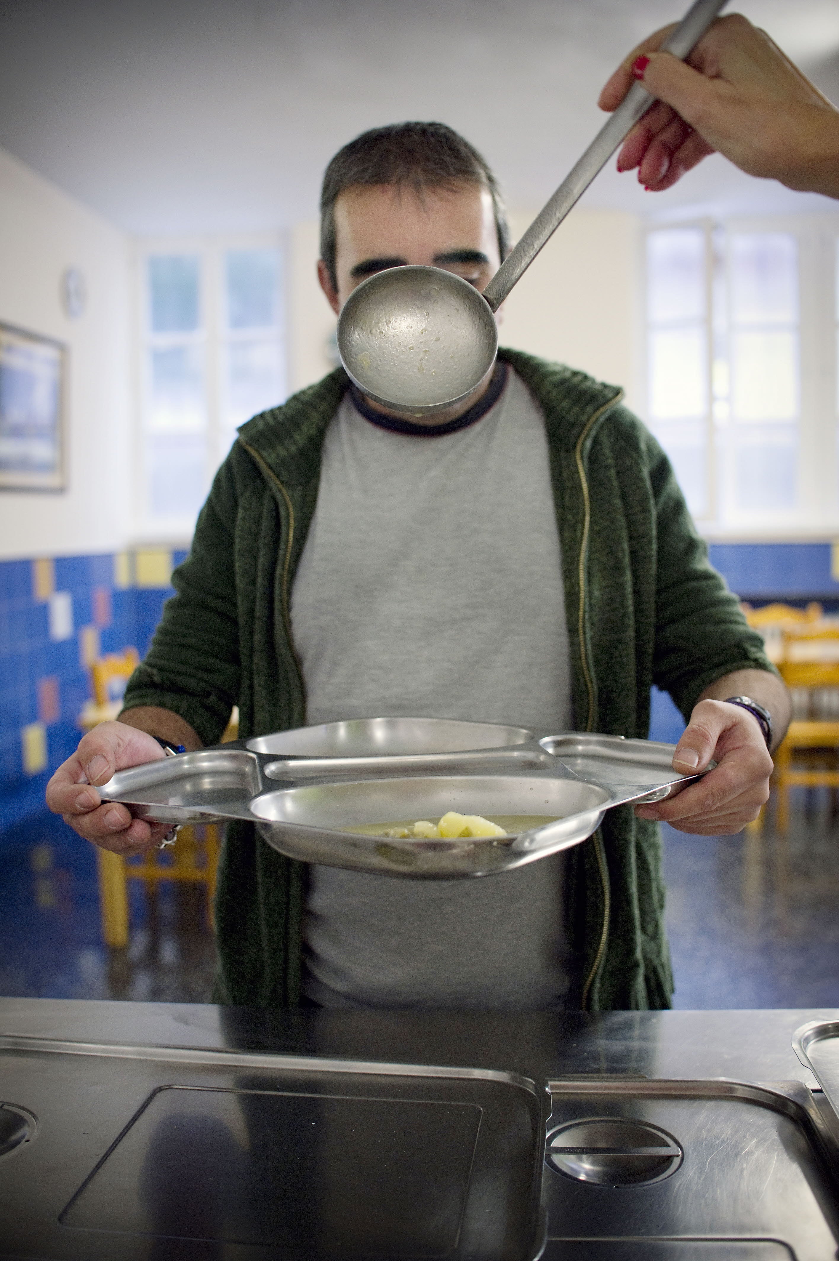 Una persona recurre a un comedor social para alimentarse. 