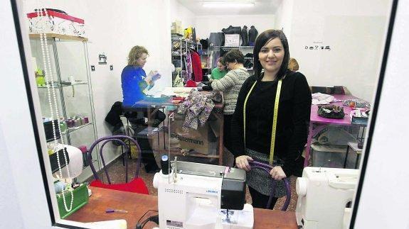 Arriba,Patricia Vázquez en su tienda de la calle de Emilio Tuya de Gijón.