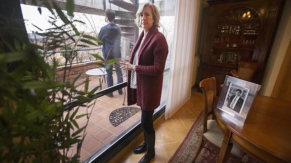 Ana Iríbar posa en su casa en Madrid junto a una fotografía de Goyo y su hijo Javier de espaldas.