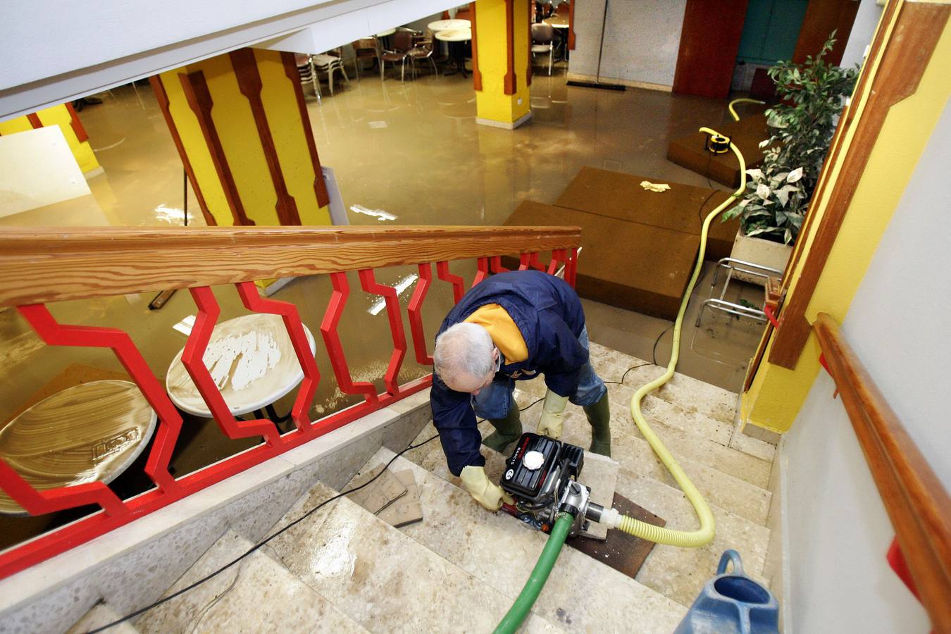 Trabajos de achique del agua con una bomba en el interior de un club social de la ciudad. 