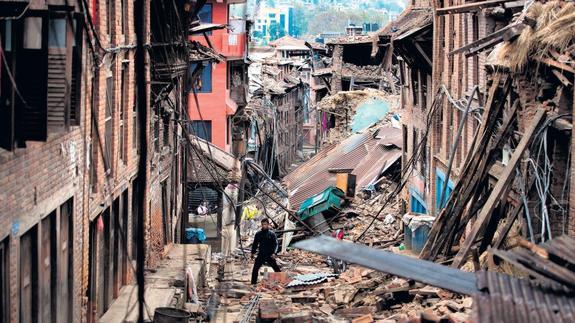 Un hombre camina entre los escombros de los edificios dañados por el terremoto en Bhaktapur, cerca de Katmandú..