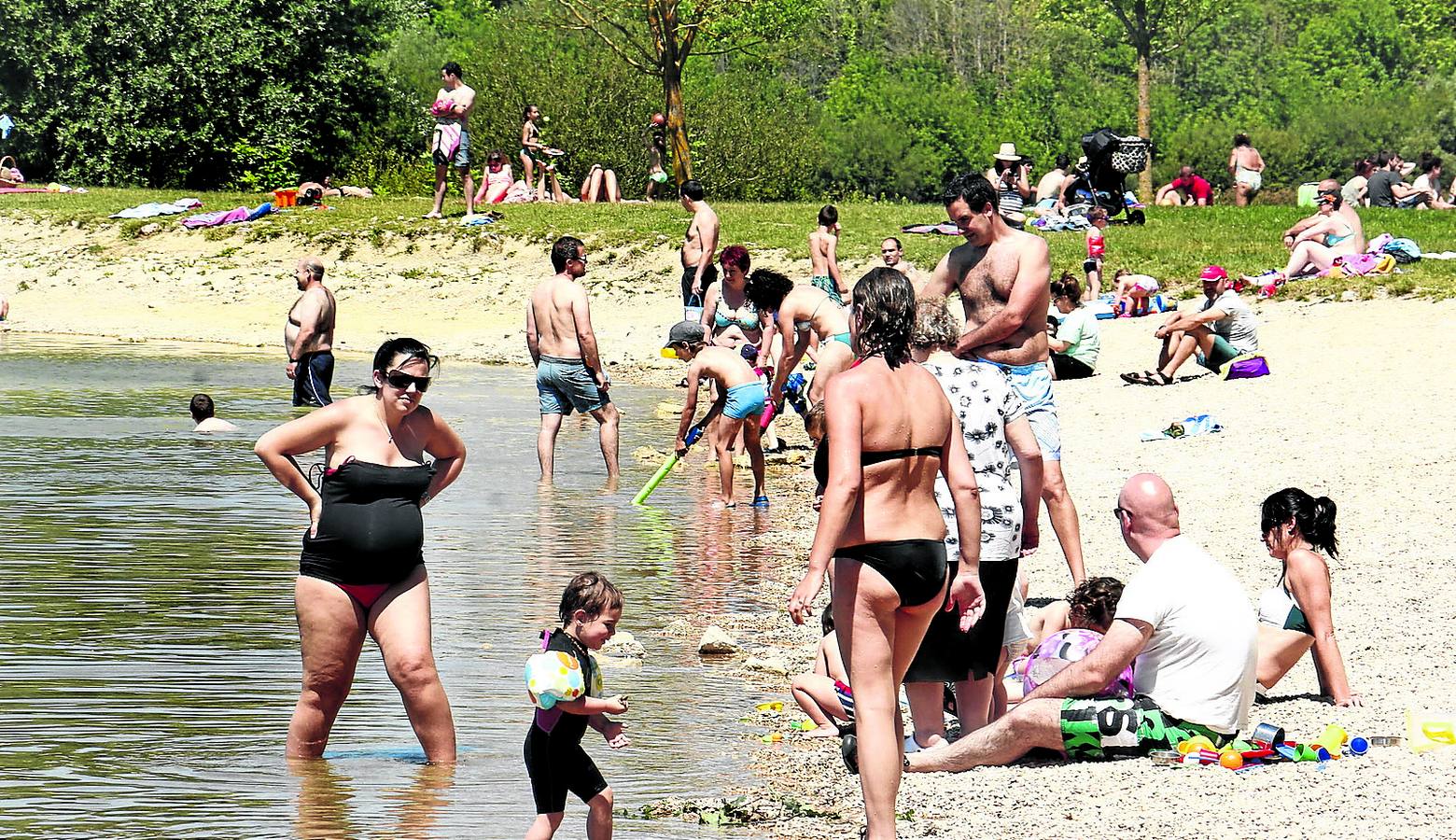 Numerosas personas disfrutan del sol y del agua en la playa de Garaio. 