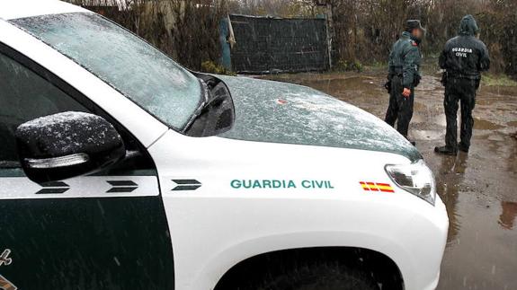 Vehículo de la Guardia Civil y dos agentes del instituto armado. 