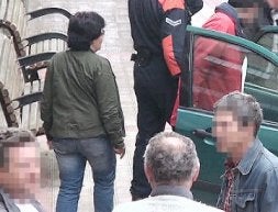 La detenida, a la izquierda, a punto de entrar en el coche policial./ L. CALABOR
