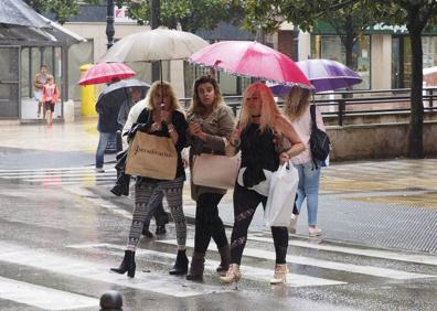 Imagen secundaria 1 - Gente bajo la lluvia, este miércoles en Torrelavega