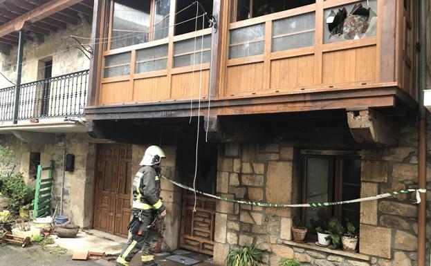 Un bombero trabaja en el exterior de la casa.