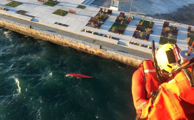 El instante en que el rescatador del helicóptero del Gobierno desciende hasta el piragüista. 