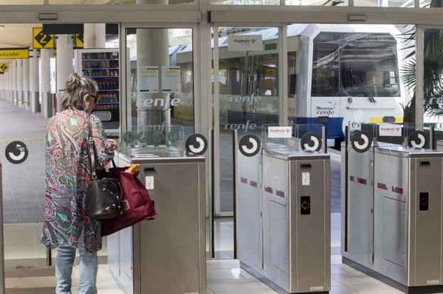 Una mujer se dispone a pasar el control de acceso en la estación de trenes de Santander. 