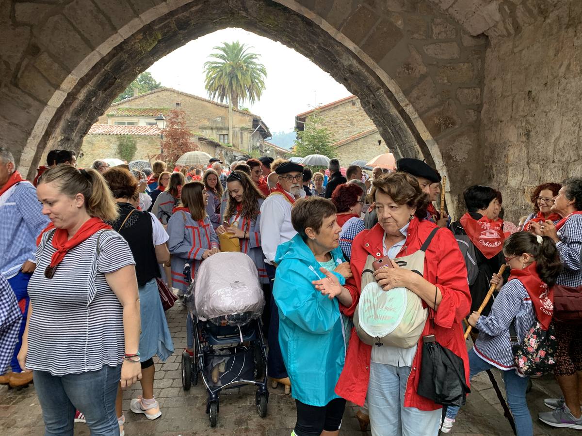 Los vecinos de Cartes tuvieron que sacar los paraguas para participar en el 'Día de las albarcas', caminando bajo la lluvia hasta Cohicillos