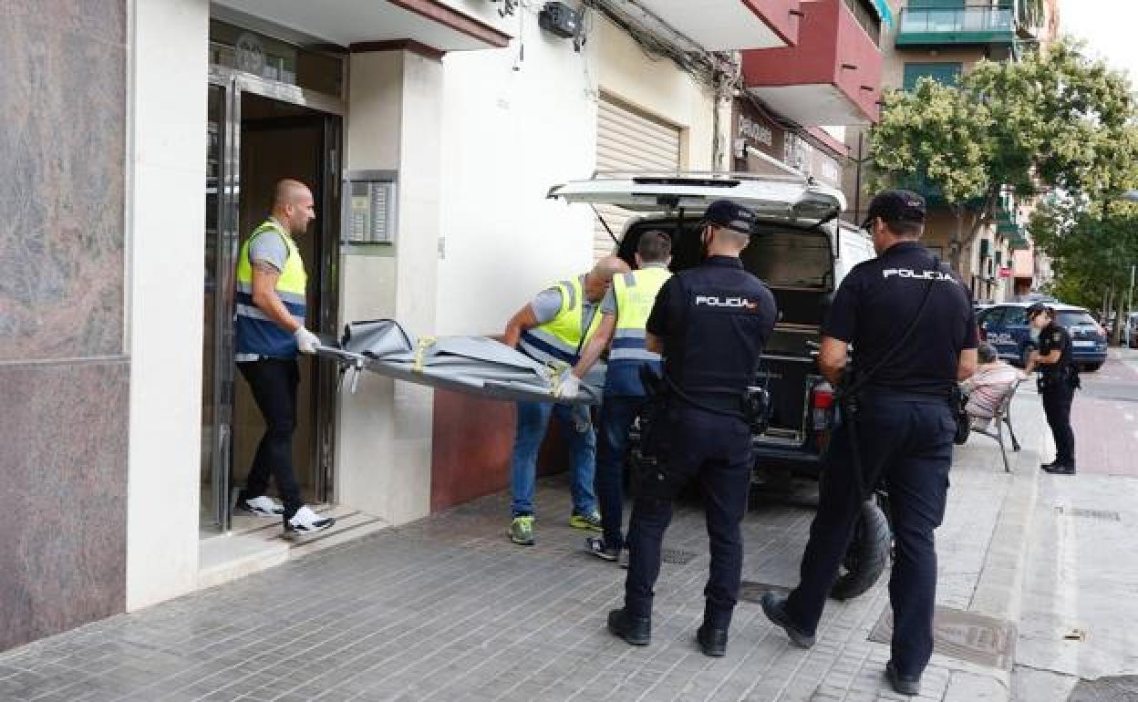 Los servicios funerarios trasladasn el cuerpo de la fallecida.