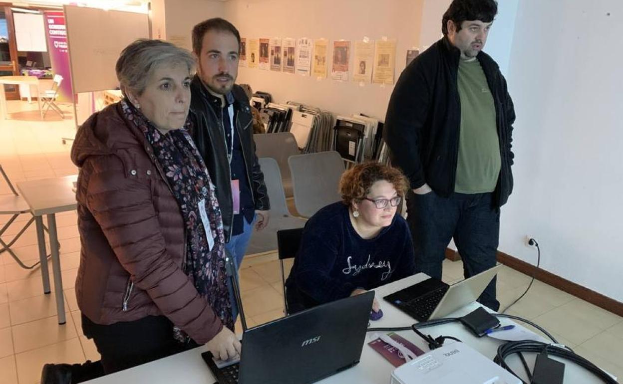 El número uno de Unidas Podemos, Luis del Piñal, y Leticia Martínez (a la izquierda), siguen el recuento de resultados en La Moraduca.