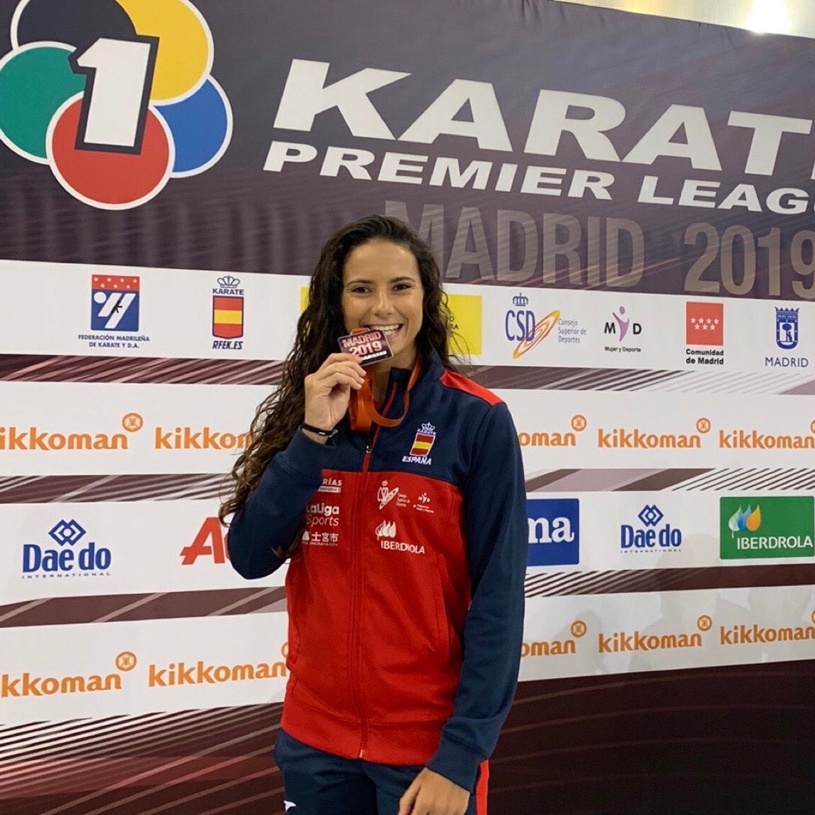 Carlota Fernández muerde su medalla de bronce.