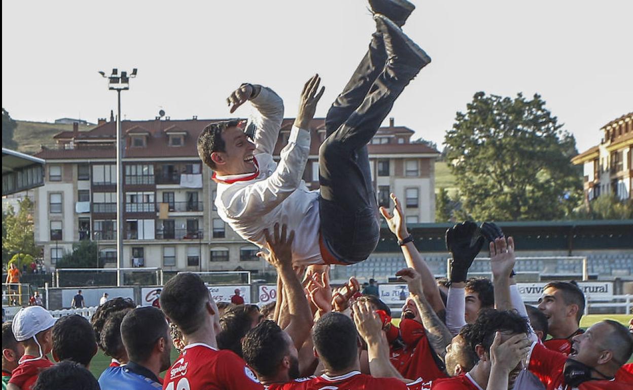 Los jugadores mantean a Raúl Pérez.